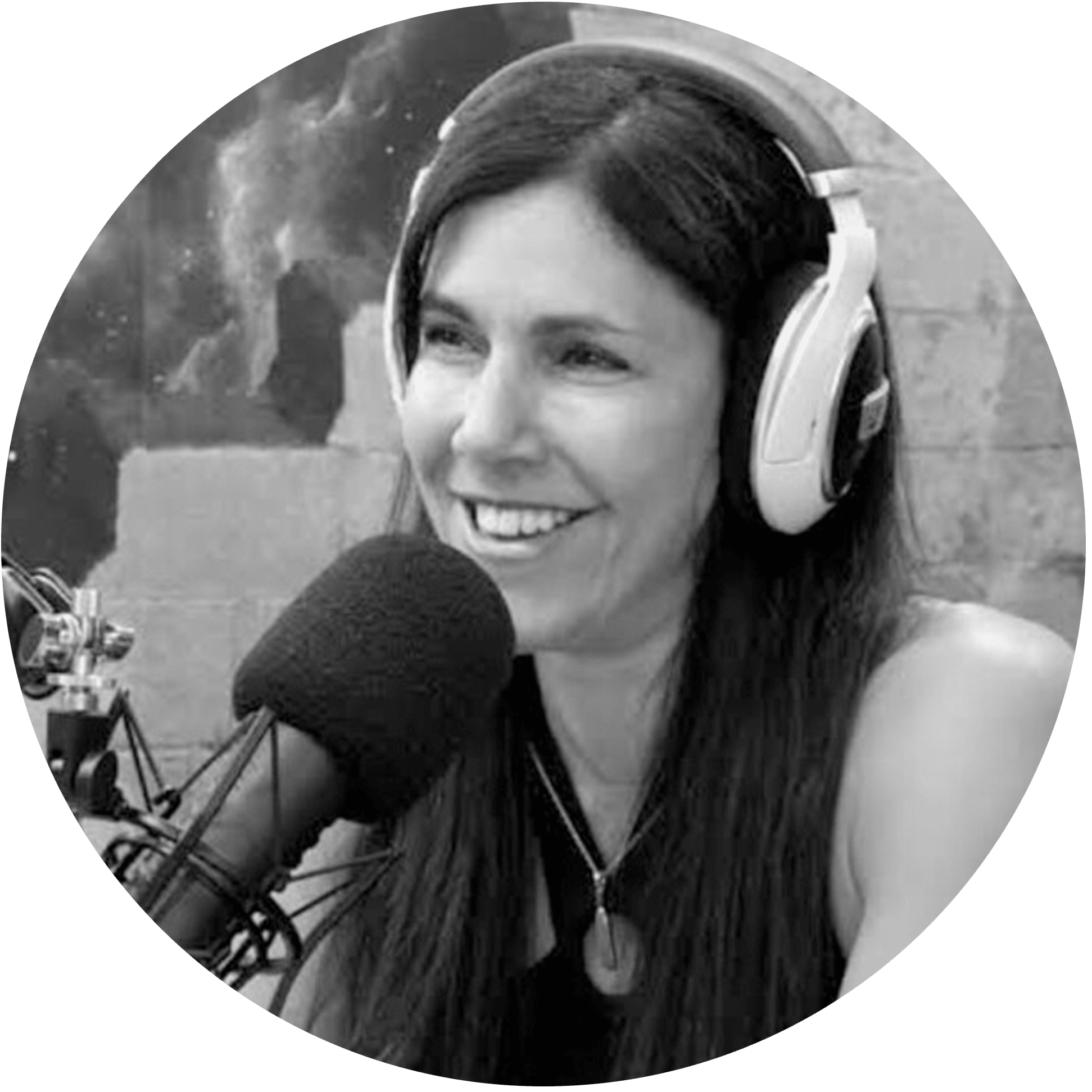 Lisa Tamati at the microphone in the podcast studio, wearing headphones
